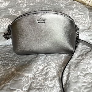 Shiny silver Kate Spade crossbody purse.
